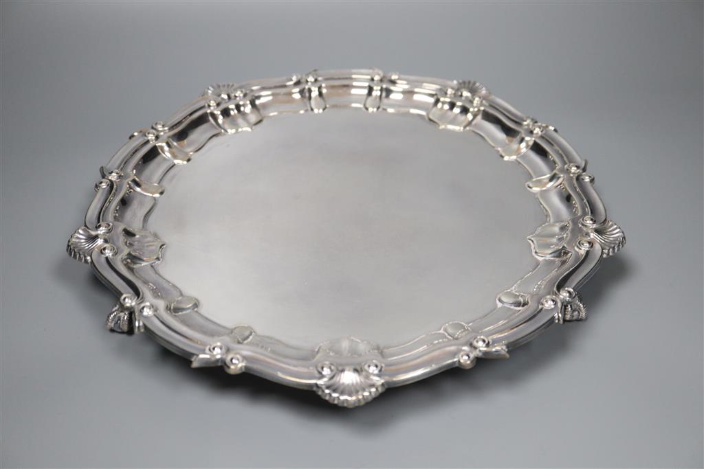 A modern circular silver salver with shell and scroll border on claw and ball feet, Birmingham, 1967, 30.3cm,